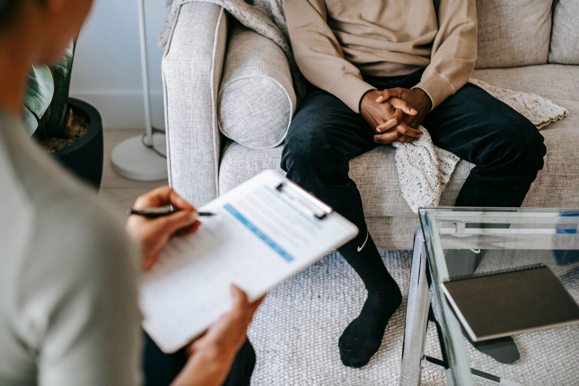Therapist taking notes during a session with a client